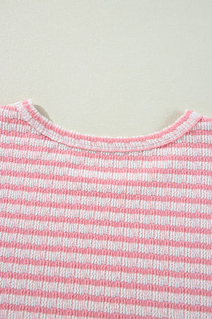 Textured stripe puff sleeve top in blush pink with a round neckline.