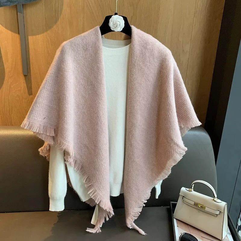 Luxurious fuzzy triangle shawl scarf in dusty pink with fringe detail, styled over a white sweater.