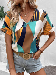 Geometric print V-neck blouse with short sleeves in multicolor.