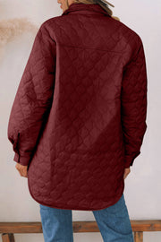 Burgundy quilted utility jacket with button cuffs and a collared neckline.