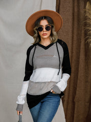Colorblock eyelet knit hoodie in black, grey, and white with a V-neck and drawstring.