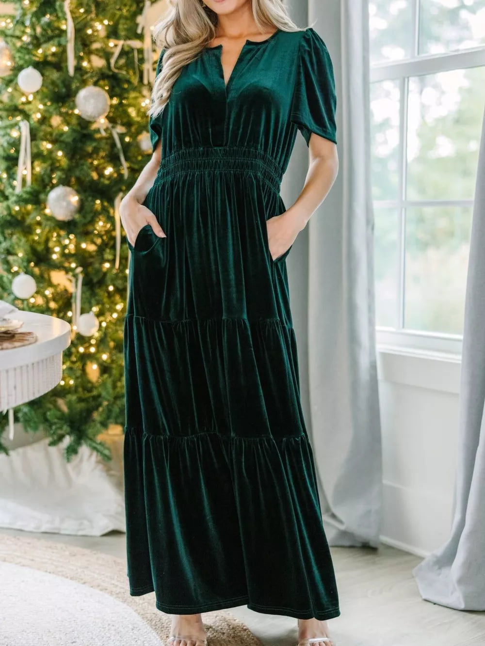 Dark green velvet maxi dress with pockets, ruched waist, tiered skirt, and short sleeves.