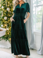 Dark green velvet maxi dress with pockets, ruched waist, tiered skirt, and short sleeves.