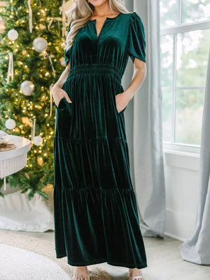 Dark green velvet maxi dress with pockets, ruched waist, tiered skirt, and short sleeves.