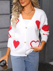 White knit cardigan with red heart pattern, button front, V-neck, long sleeves.