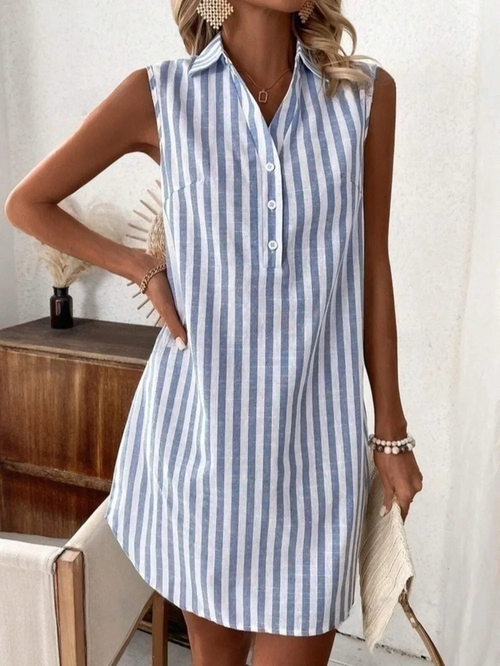 Light blue and white striped sleeveless collared shirt dress with button front