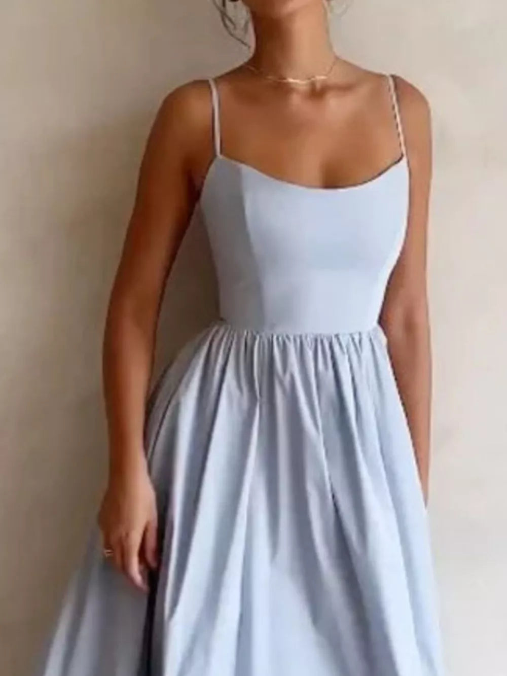 Light blue midi dress with adjustable straps and a-line skirt, perfect for casual wear.