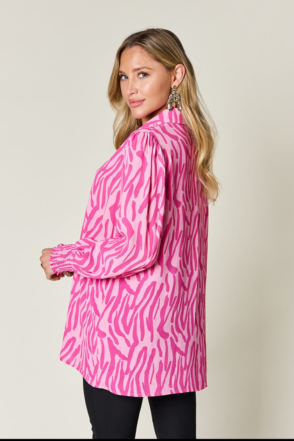 Pink zebra print blouse with shirred cuffs and puff sleeves.