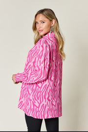 Pink zebra print blouse with shirred cuffs and puff sleeves.