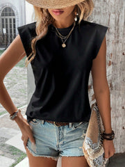 Black cap sleeve blouse with padded shoulders, styled with denim shorts.