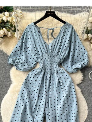 Light Blue polka dot smocked wide-leg romper with V-neck and tie back.