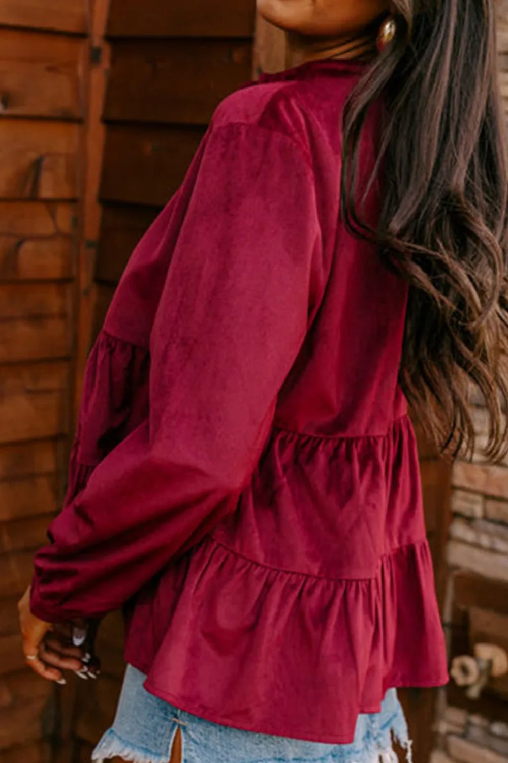 Burgundy corduroy tiered button-up blouse with long sleeves and ruffled tiers.