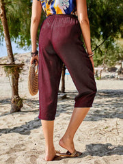 Burgundy elastic waist cropped denim trousers with a relaxed fit.