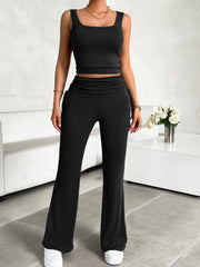 Black ribbed tank top and ruched waist flare pants set with drawstring details.