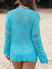 Open-knit beach cover-up in pastel blue with slit hem and open knit sleeves.