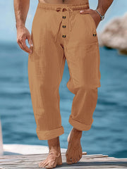 Relaxed fit drawstring sweatpants in earthy yellow with button-fly detail and cuffed hems.