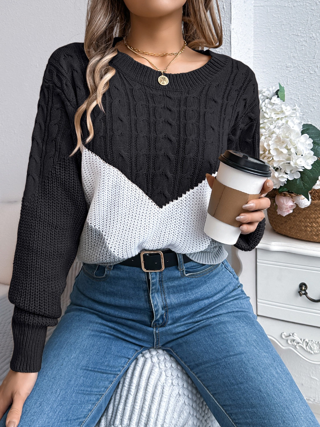 Black and white chevron cable knit sweater with crew neck.