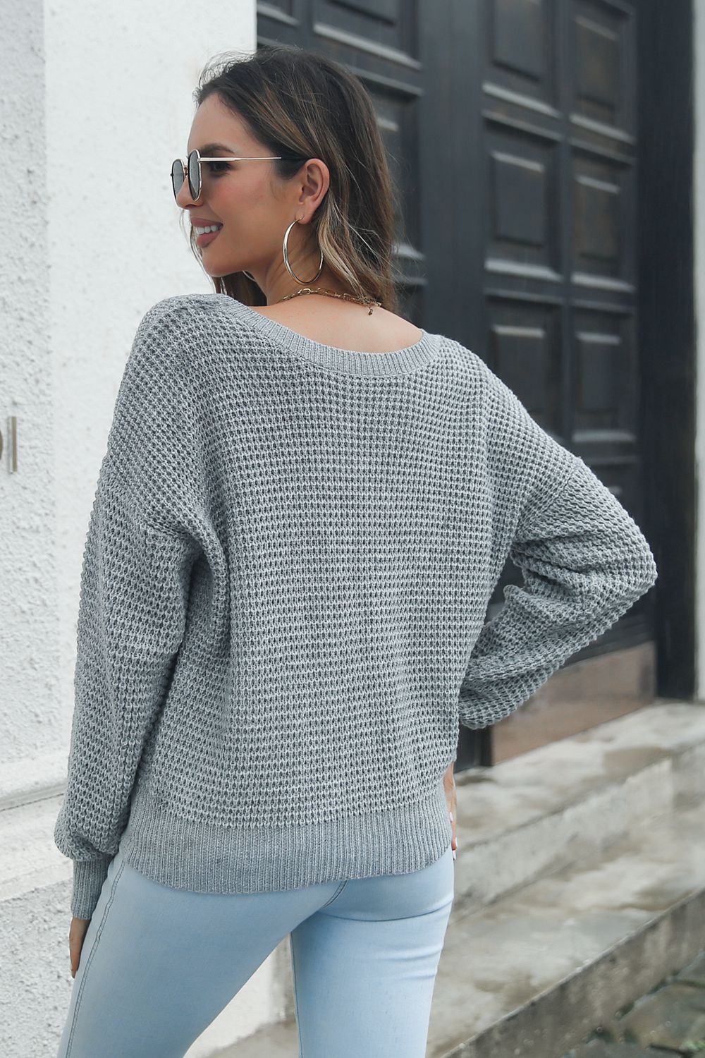 Dark gray waffle knit sweater with crew neck and long sleeves.
