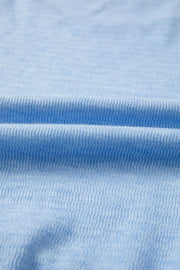 Light blue knit fabric detail with ribbed texture.