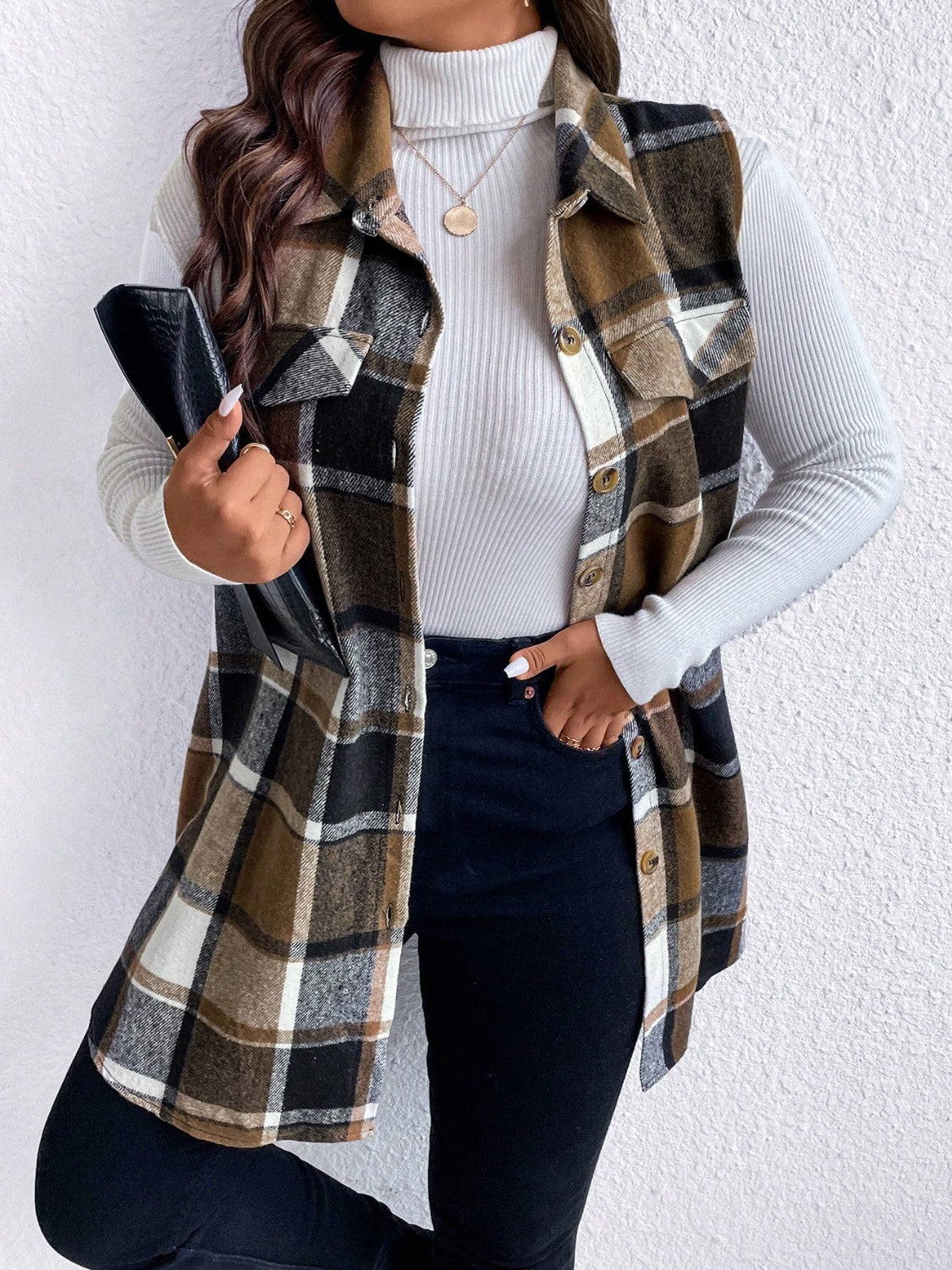Oversized plaid shirt vest in brown, black, and white with button front and chest pockets.