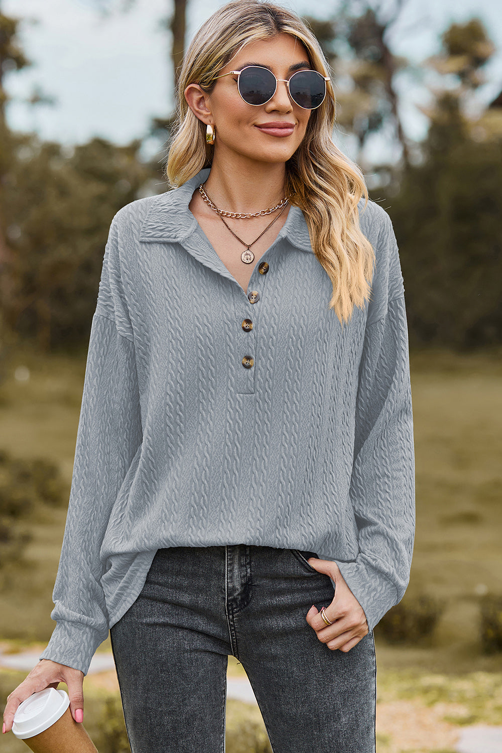 Light blue textured polo-neck sweater with button detail and long sleeves.