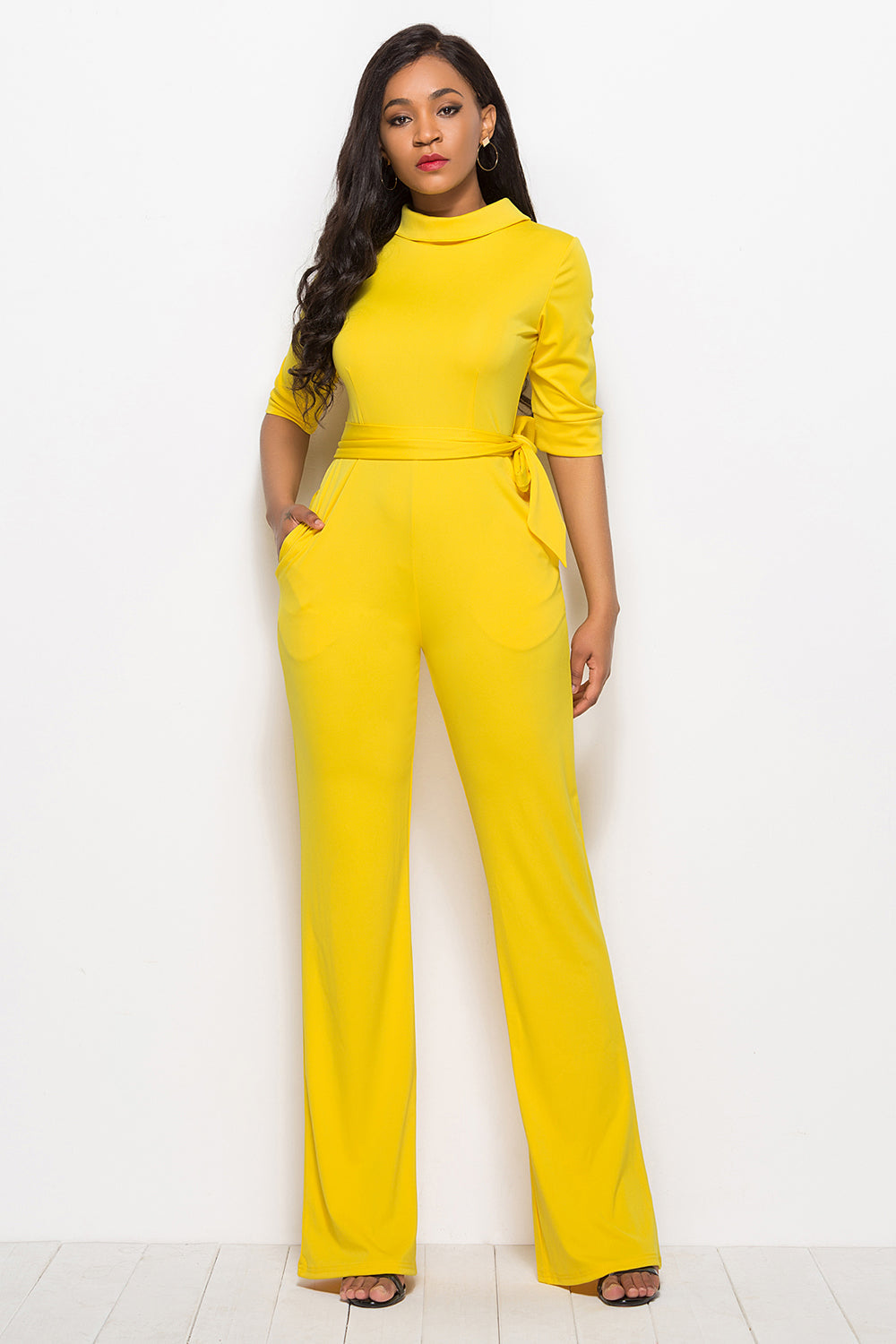 Yellow high-neck belted palazzo jumpsuit with 3/4 sleeves and pockets.