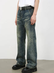 Vintage wash flare leg jeans in medium blue denim with whiskering and distressed details.