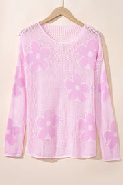 Openwork floral intarsia sweater in blush pink acrylic with a v-neck and long sleeves.