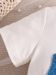 White cotton toddler t-shirt sleeve with blue textured applique detail.