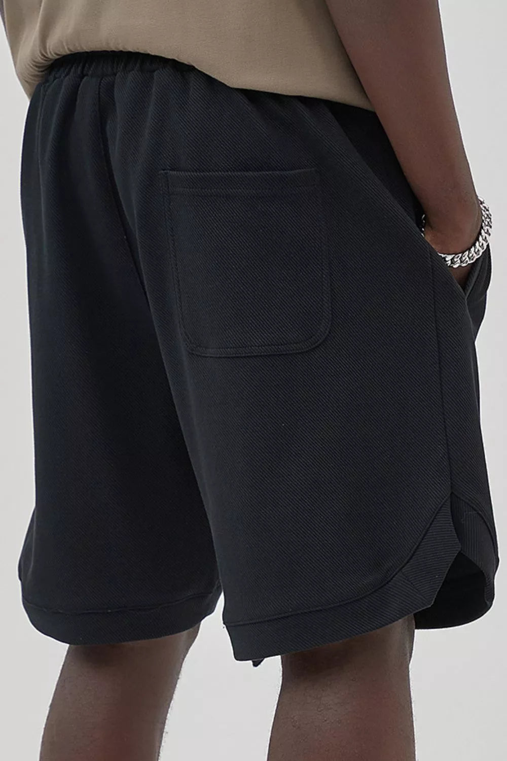 Black drawstring boxer shorts with a textured fabric and back pocket detail.