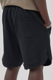 Black drawstring boxer shorts with a textured fabric and back pocket detail.