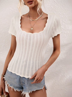 White knit top with scalloped square neckline and short sleeves, featuring a subtle chevron pattern.