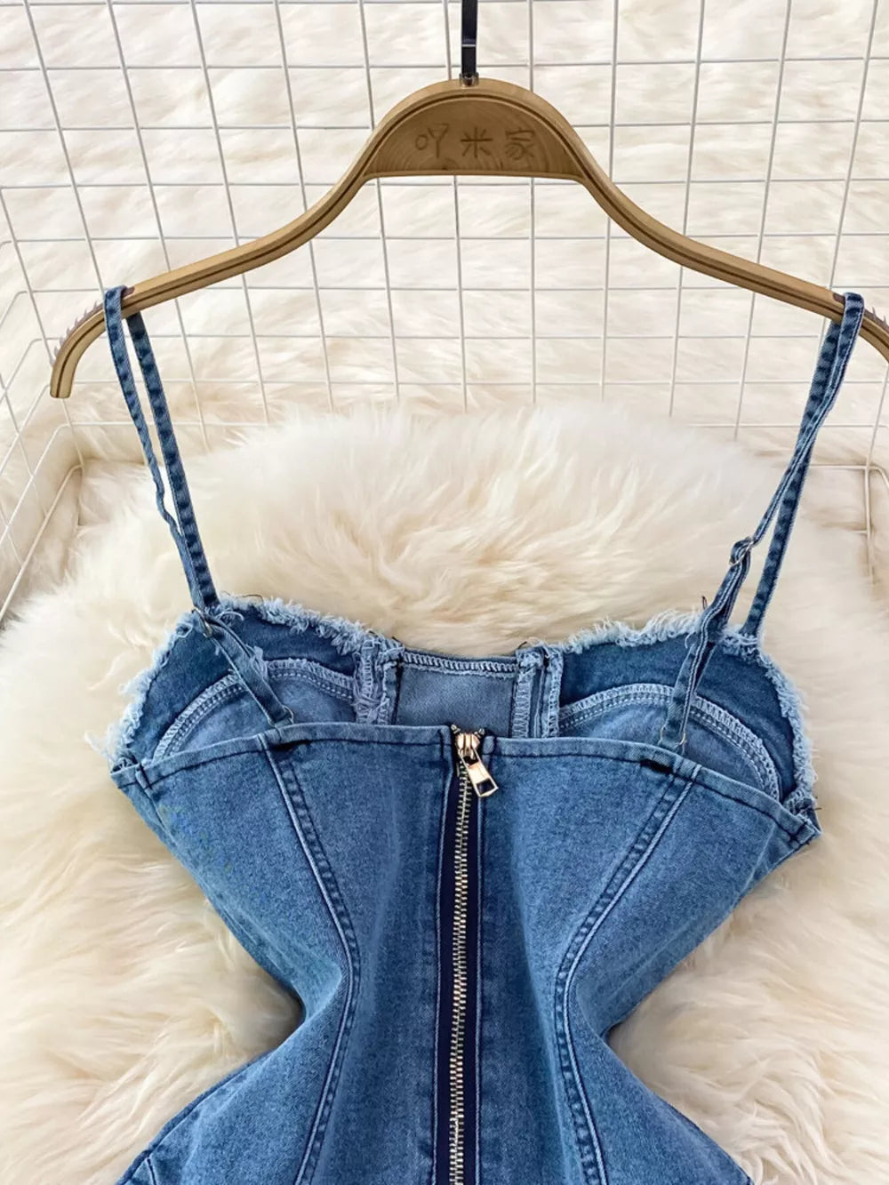 Blue denim corset dress with spaghetti straps and front zipper detail.