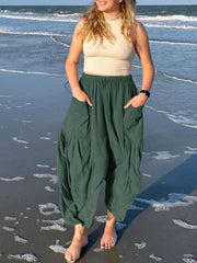 Dark green linen balloon trousers with cargo pockets and elastic waist