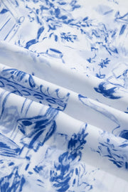 Safari-inspired V-neck shirt in white with blue toile print, polyester fabric.