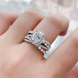 Triple band silver ring with oval moissanite halo and diamond accents
