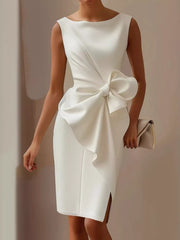 White sleeveless dress with large bow detail and side slit