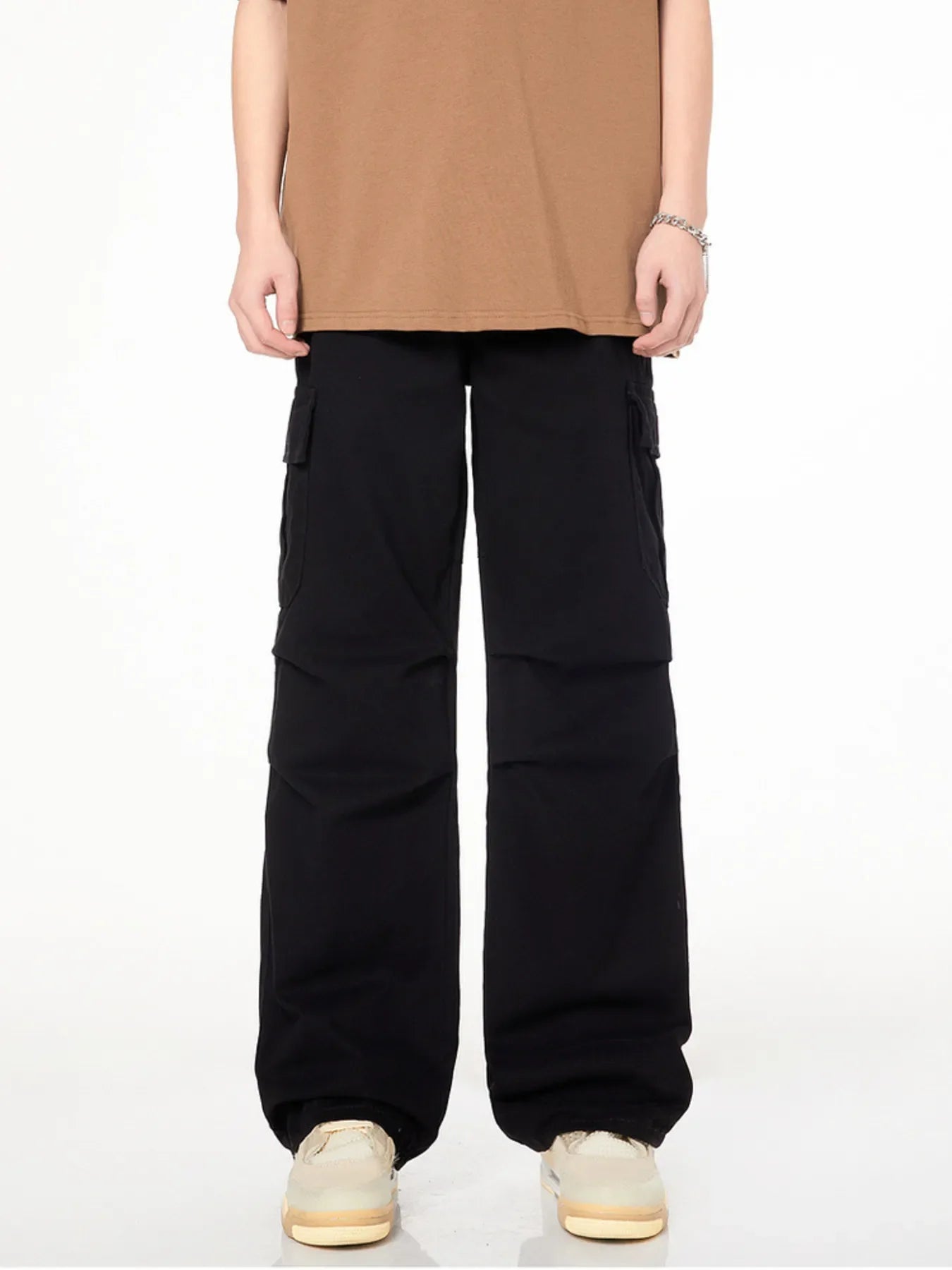 Men's black loose fit cargo pants with multiple pockets and a casual style.