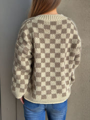 Checkerboard knit button-up cardigan in taupe and cream acrylic with a crew neck.