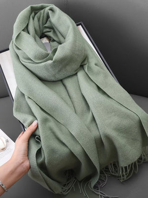 Light green scarf with fringe detail and textured weave, shown draped.