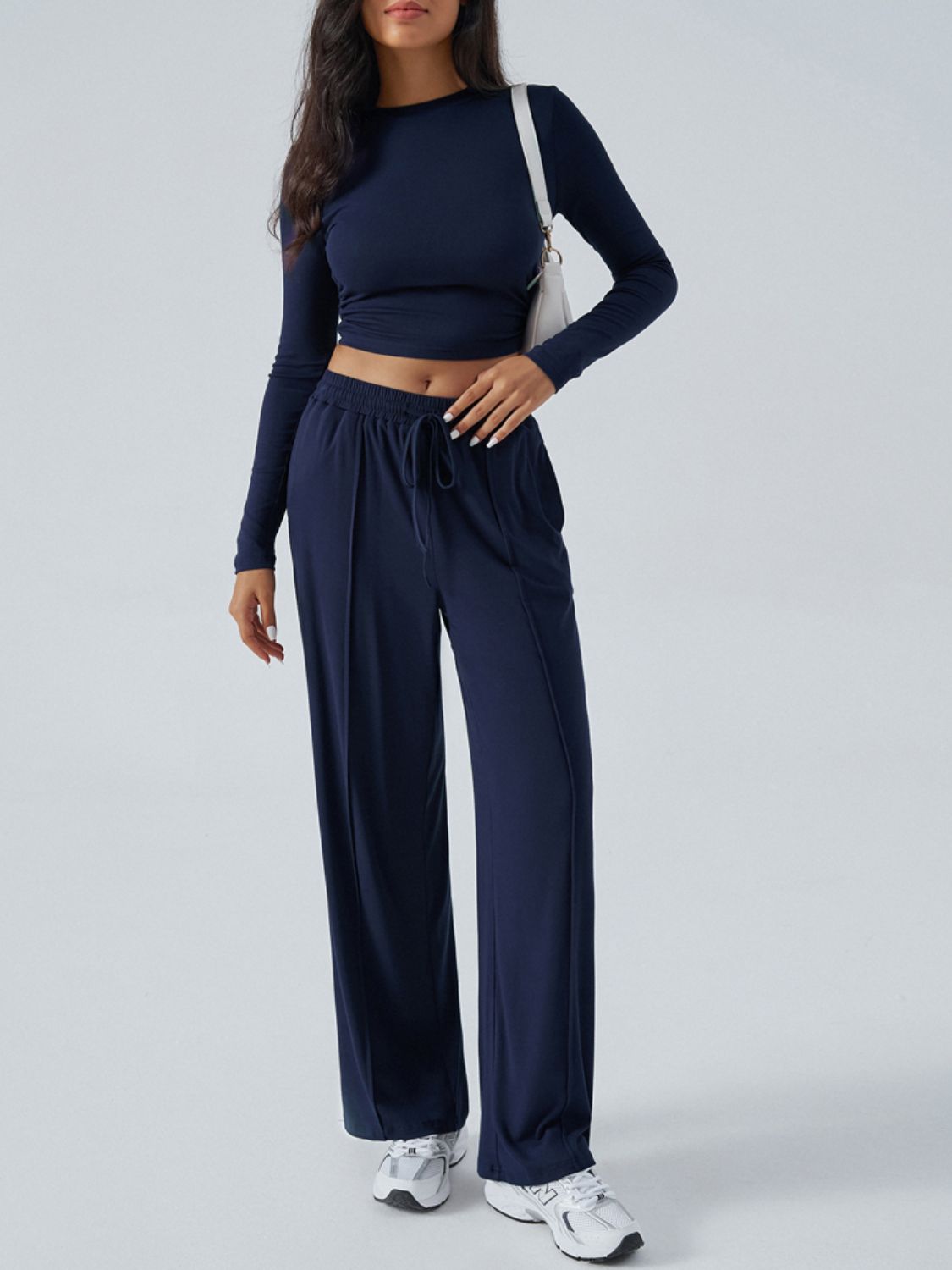 Dark blue ribbed knit crop top and wide leg pants set with drawstring waist.