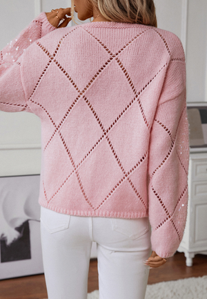 Blush pink knit sweater with diamond cutwork and sequin details on sleeves.
