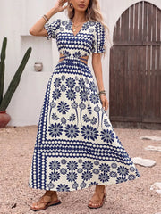 Maxi dress with blue floral print, cutout waist, V-neck, and short puff sleeves.