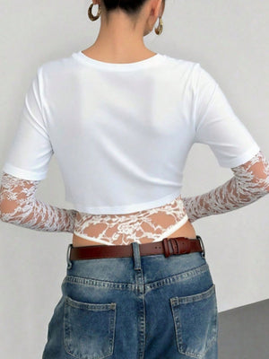 White lace patchwork bodysuit with sheer sleeves and intricate lace detailing.