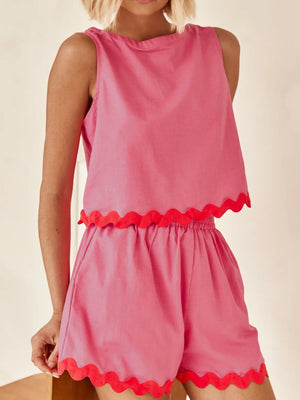 Scalloped edge tank and shorts set in fuchsia pink with red trim.