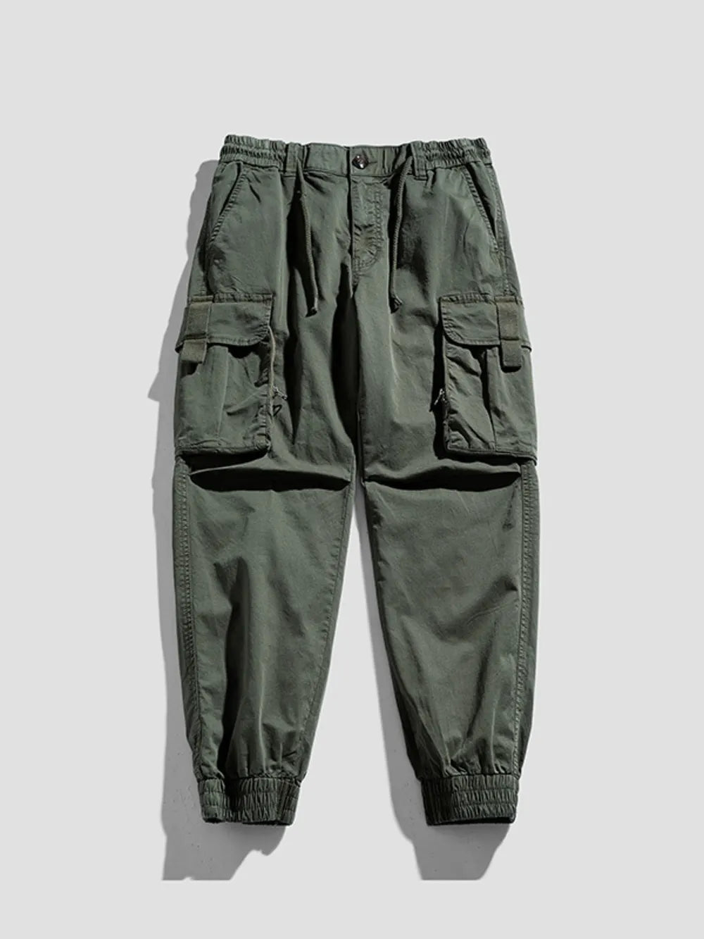 Army green cargo joggers with flap pockets and elastic cuffs.