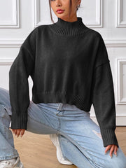 Black cropped ribbed turtleneck sweater with long sleeves and ribbed cuffs.
