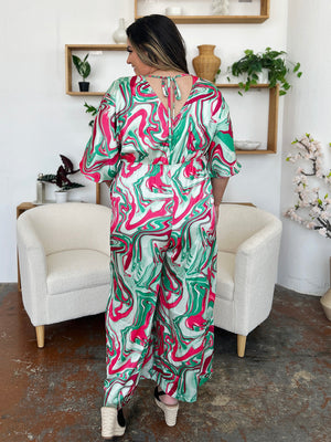 Green swirl print kimono sleeve jumpsuit with tie back detail.