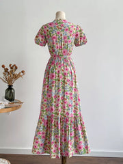 Maxi dress with short sleeves, V-neck, and a tiered hem in a whimsical floral print.