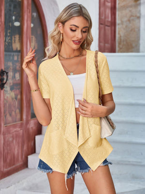 Light yellow perforated shawl collar jacket with short sleeves and pockets.
